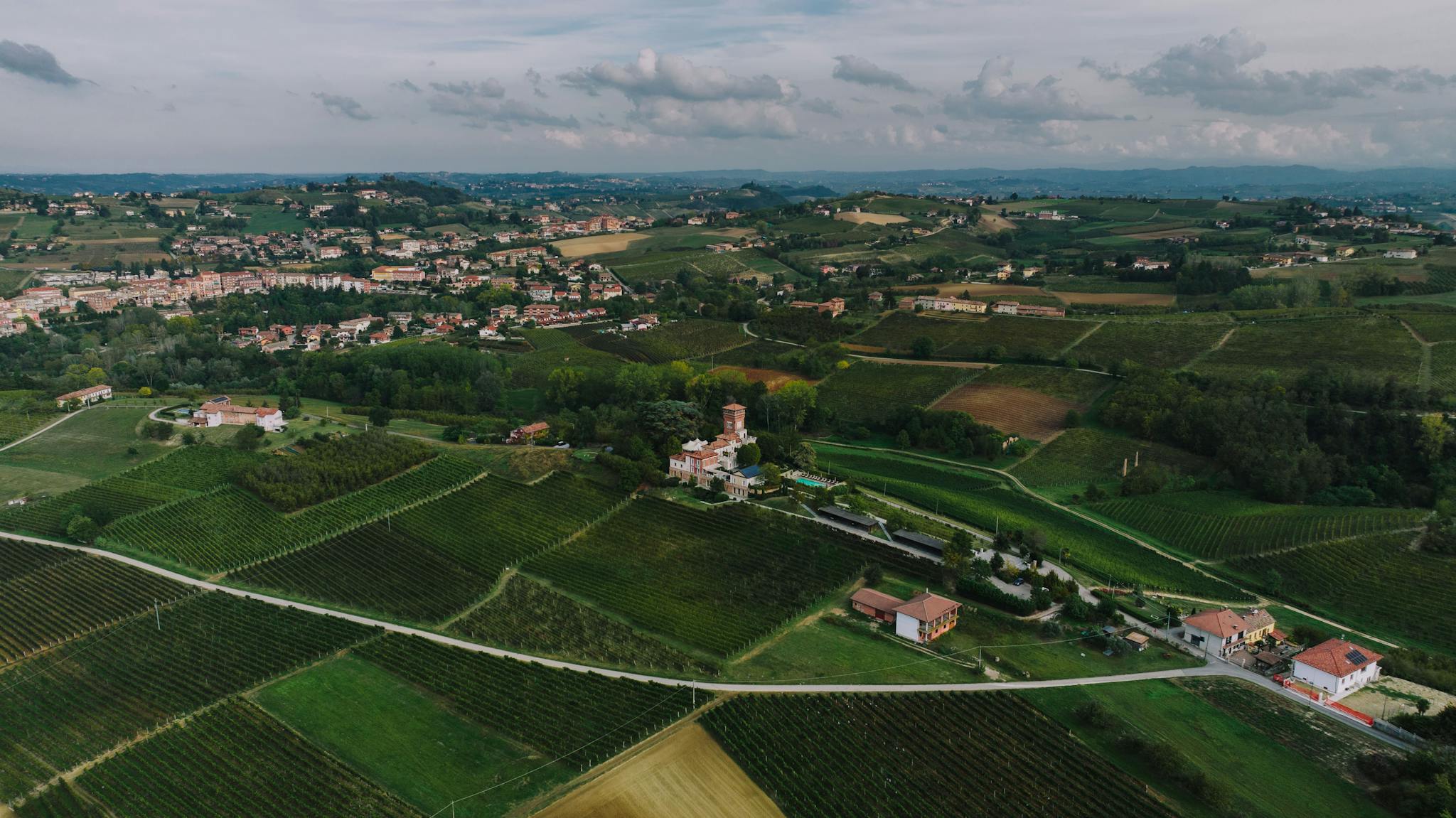 Breathtaking aerial view of the lush vineyards and countryside of Costigliole d'Asti, Piedmont, Italy.